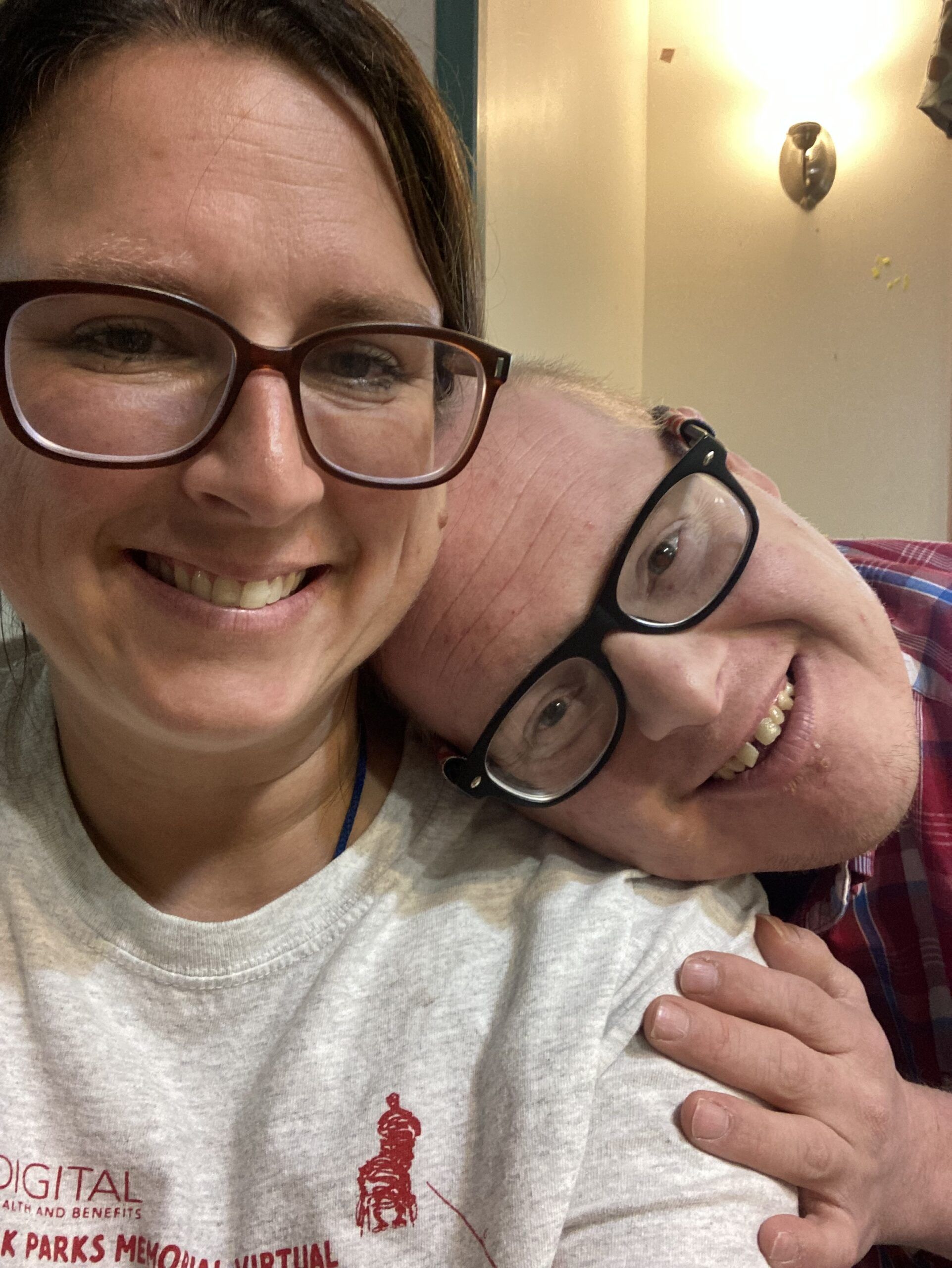 Male resident hugging female staff member