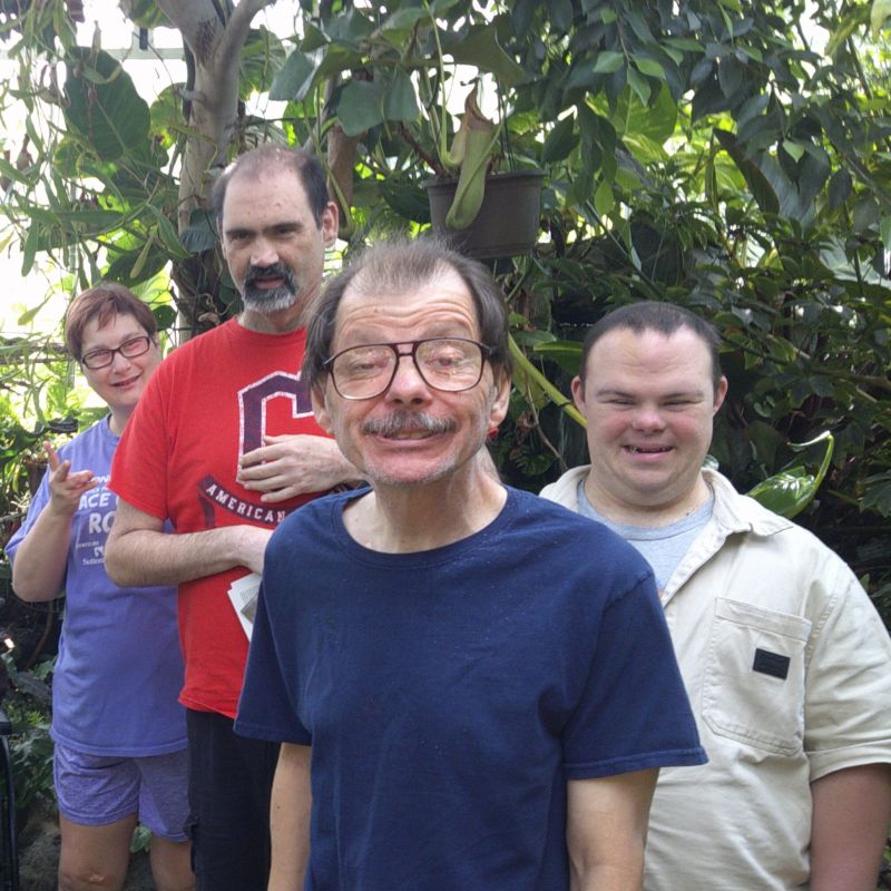 Four individuals posing at a group outing
