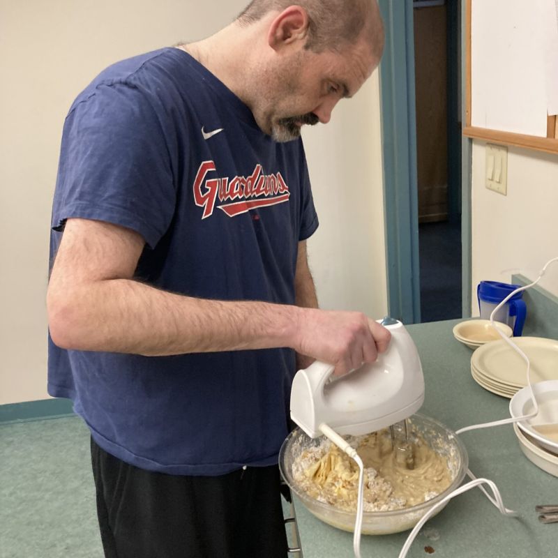 Individual using a hand mixer