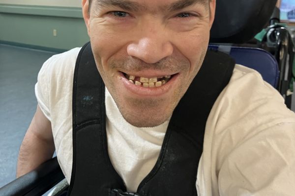 Male in chair smiling